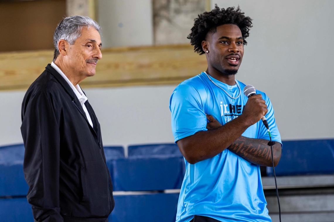 Miami Heat guard Davion Mitchell, right, speaks to campers alongside Tony Fiorentino, left, during Jr. Heat Basketball Camp at SLAM! on Tuesday, July 8, 2025, in Miami, Fla.