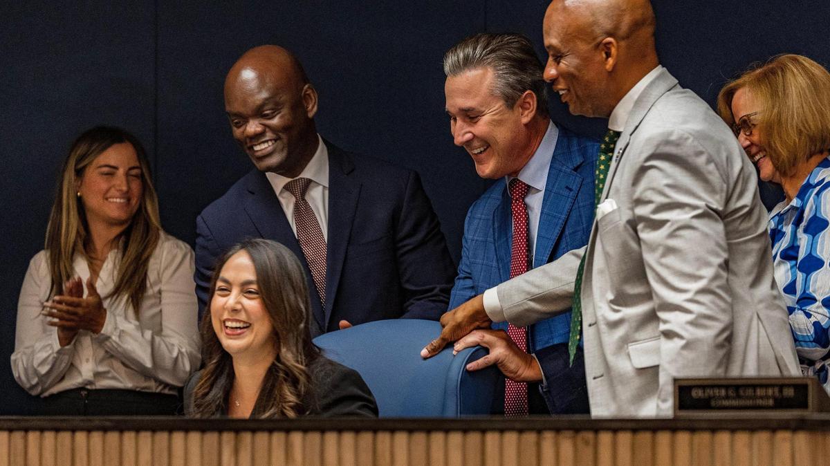Former city of West Miami Vice Mayor Natalie Milian Orbis reacts as commissioners (from left) Vice Chairman Kionne L. McGhee, René Garcia, Oliver G. Gilbert III and Eileen Higgins pulled out her chair at a commission meeting after being appointed as the new county commissioner on Tuesday, May 6, 2025.