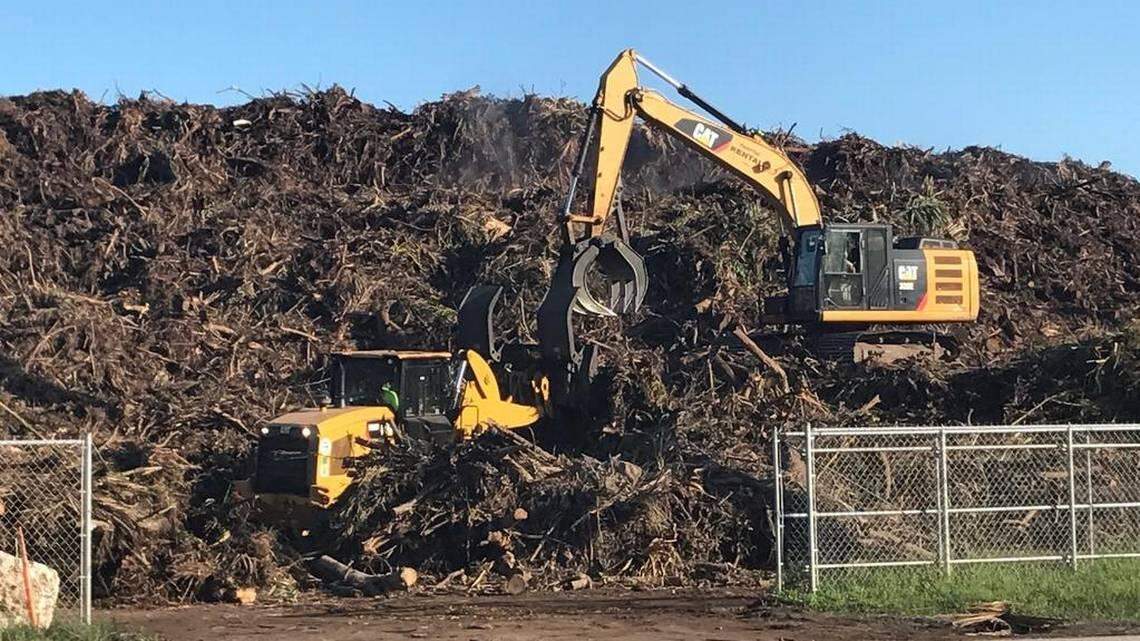 A crane adds to an ever-growing pile of vegetative debris from Hurricane Irma at a Key Largo site, one of several throughout the Florida Keys in the aftermath of Hurricane Irma, which struck the Keys on Sept. 10, 2017.