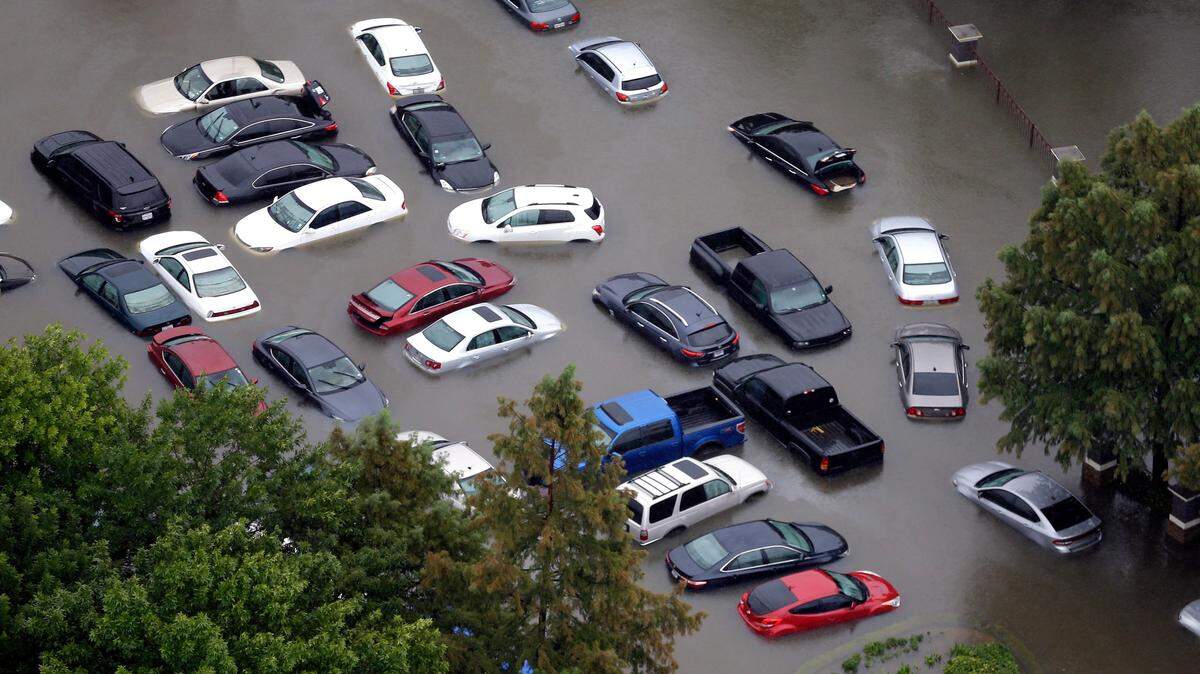 Cars are flooded near the Addicks Reservoir as floodwaters from Harvey rise in Houston in 2017. Hurricanes Irma in Florida and Harvey in Texas last year left behind a large number of flood-damaged vehicles that are now offered on the used car market.