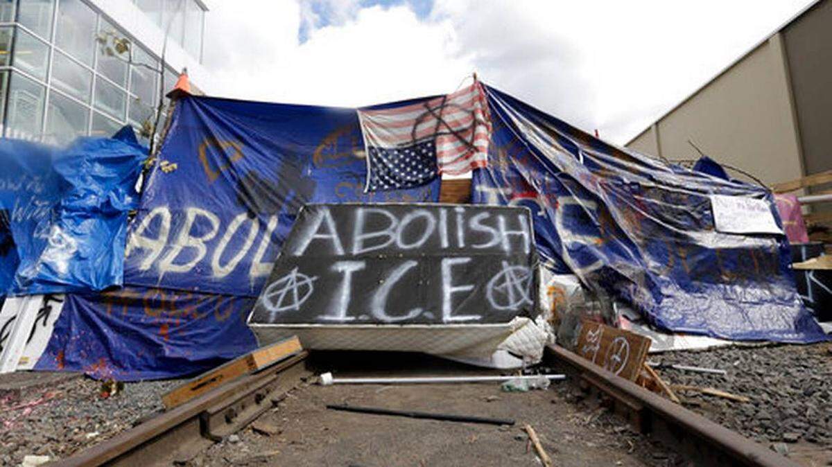 A barricade crosses railroad track at a protest camp on property outside the U.S. Immigration and Customs Enforcement office in Portland, Ore., Monday, June 25, 2018.