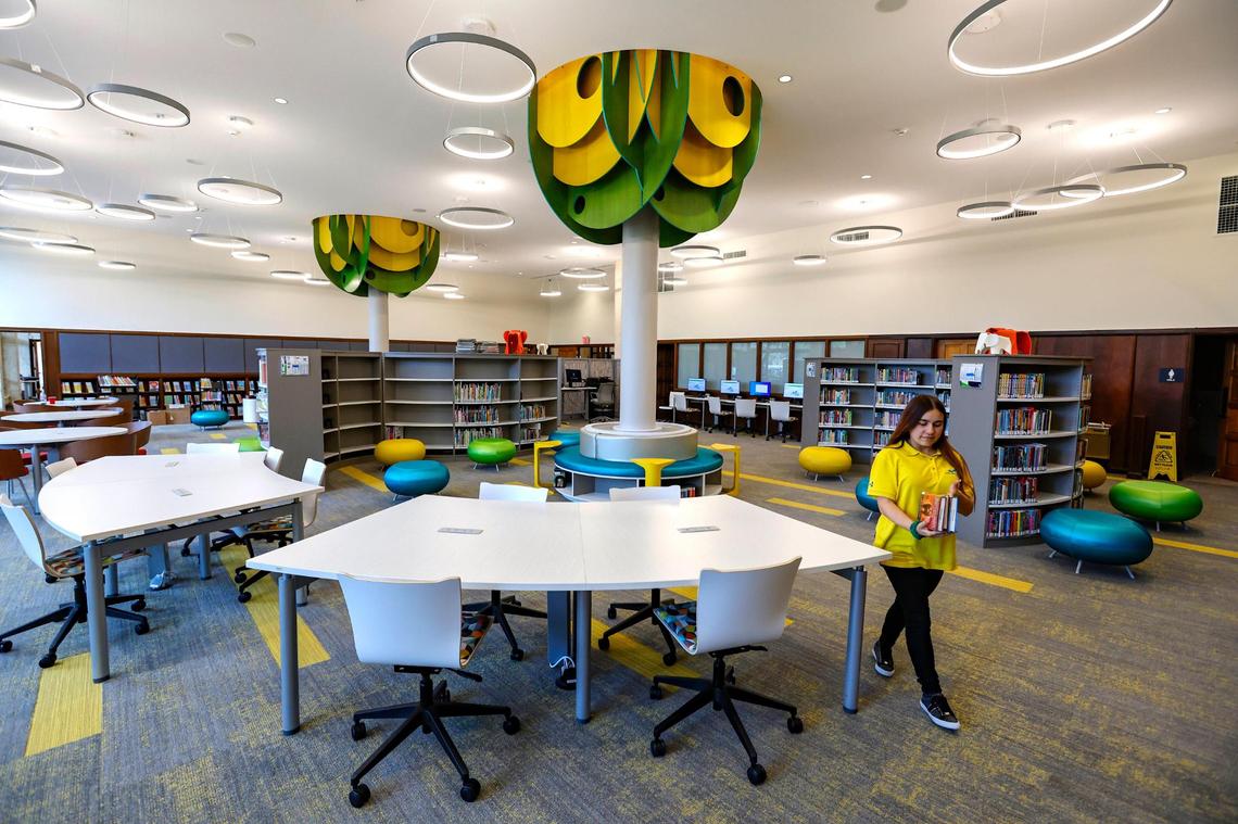 Librarian Lucy Laso helps prepare the children’s room at the Coral Gables Branch Library which reopens on Monday, May 22 after closing for renovations in 2021. The library is located at 3443 Segovia Street in Coral Gables on Tuesday, May 16, 2023.