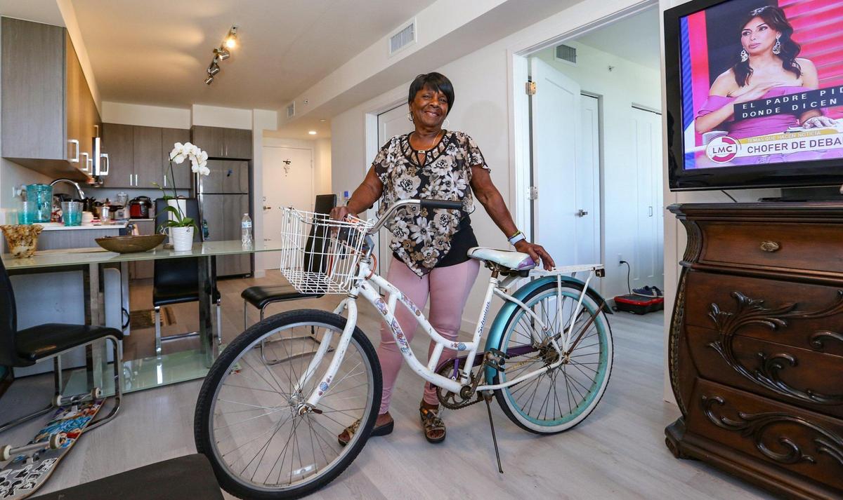 Resident, Elina Crespo, 72, stores her bike at her apartment rental unit on Wednesday, April 27, 2022, at Brisas del Este, which is part of the Three Round Towers complex.