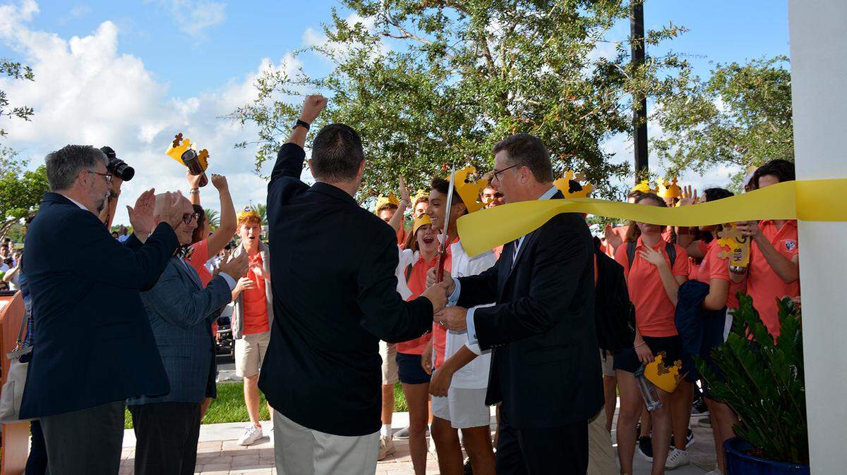 With scissors in hand, Palmer Trinity School’s Patrick Roberts, head of school, and Michael Baiamonte, chairman of the board of trustees, cut the ribbon to the new classroom building during an inauguration ceremony on the first day of school.