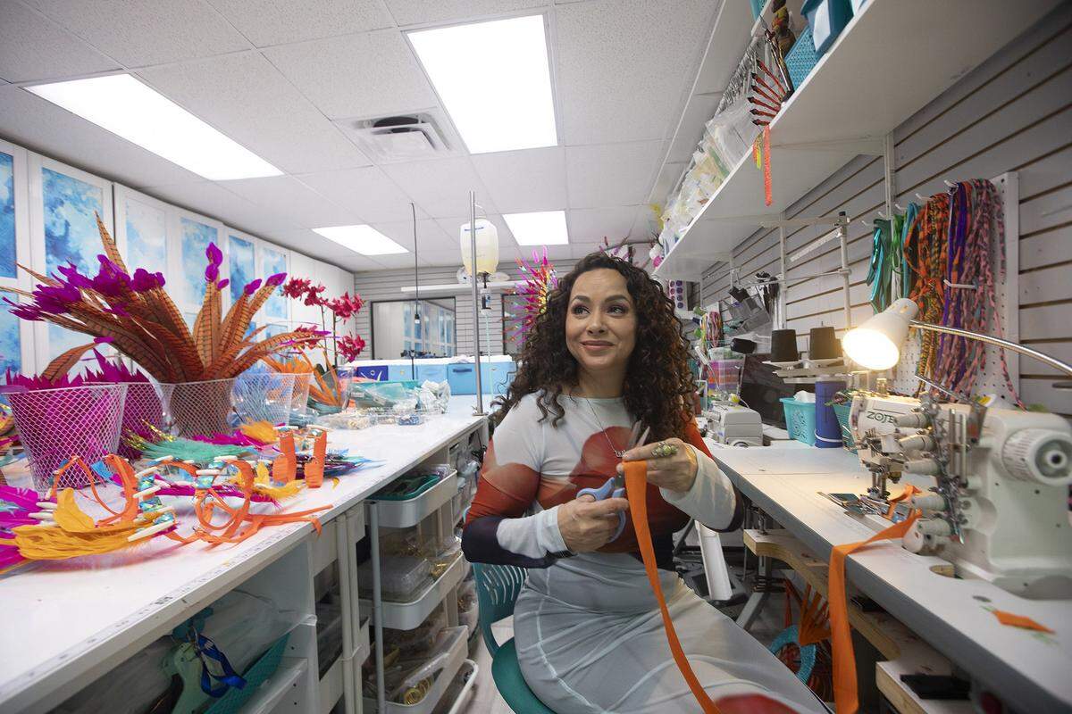 Designer Lila Nikole works on one of her carnival costumes, decorated with gemstones, feathers and bright colors, at her studio in North Miami Beach, Fla., Wednesday, Oct. 1, 2025.