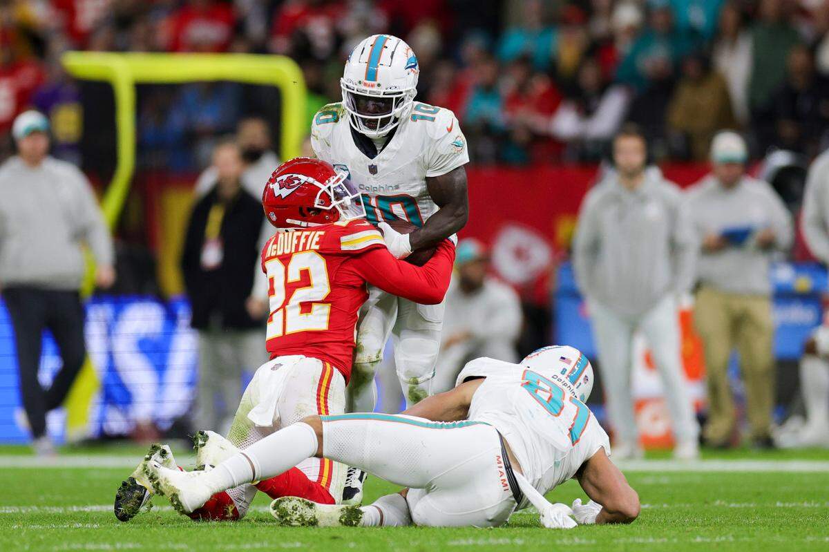 Nov 5, 2023; Frankfurt, Germany, ; Kansas City Chiefs cornerback Trent McDuffie (22) forces a fumble by Miami Dolphins wide receiver Tyreek Hill (10) in the second quarter during an NFL International Series game at Deutsche Bank Park. Mandatory Credit: Nathan Ray Seebeck-USA TODAY Sports