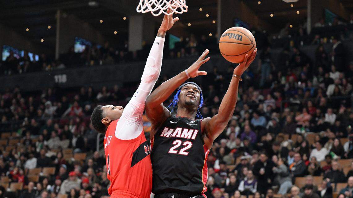 Miami Heat forward Jimmy Butler (22) shoots the ball as Toronto Raptors forward RJ Barrett (9) defends in the first half at Scotiabank Arena.