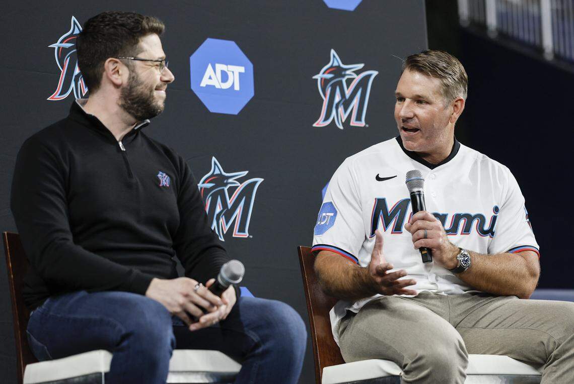 Miami Marlins coach Clayton McCullough, at right, speaks with president of baseball operations Peter Bendix.