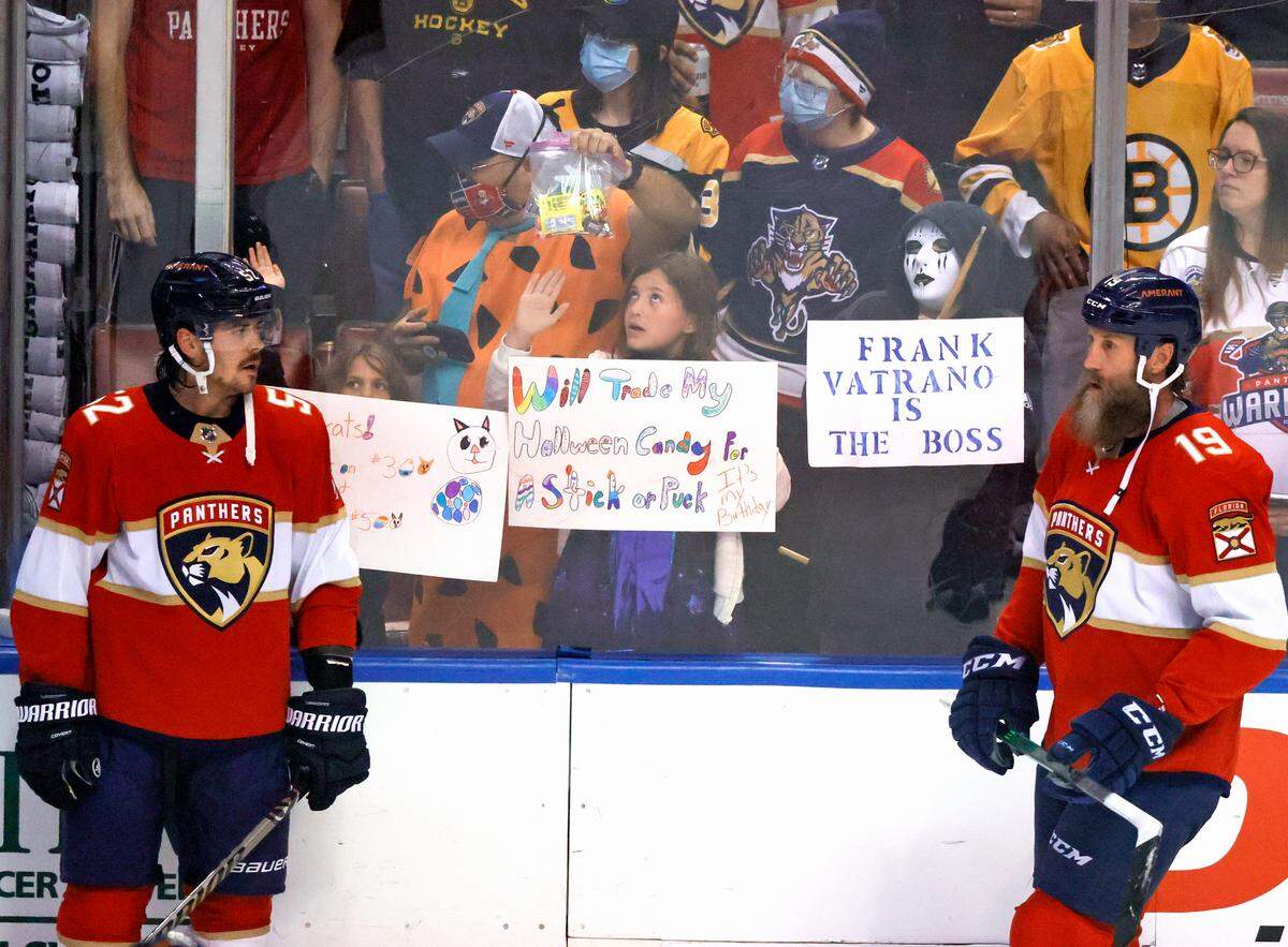 Florida Panthers defenseman MacKenzie Weegar (52) and center Joe Thornton (19) talk as Panthers fans wearing costumes during Halloween night before the start of an NHL game against the Boston Bruins at the FLA Live Arena on Wednesday, October 27, 2021 in Sunrise, Fl.