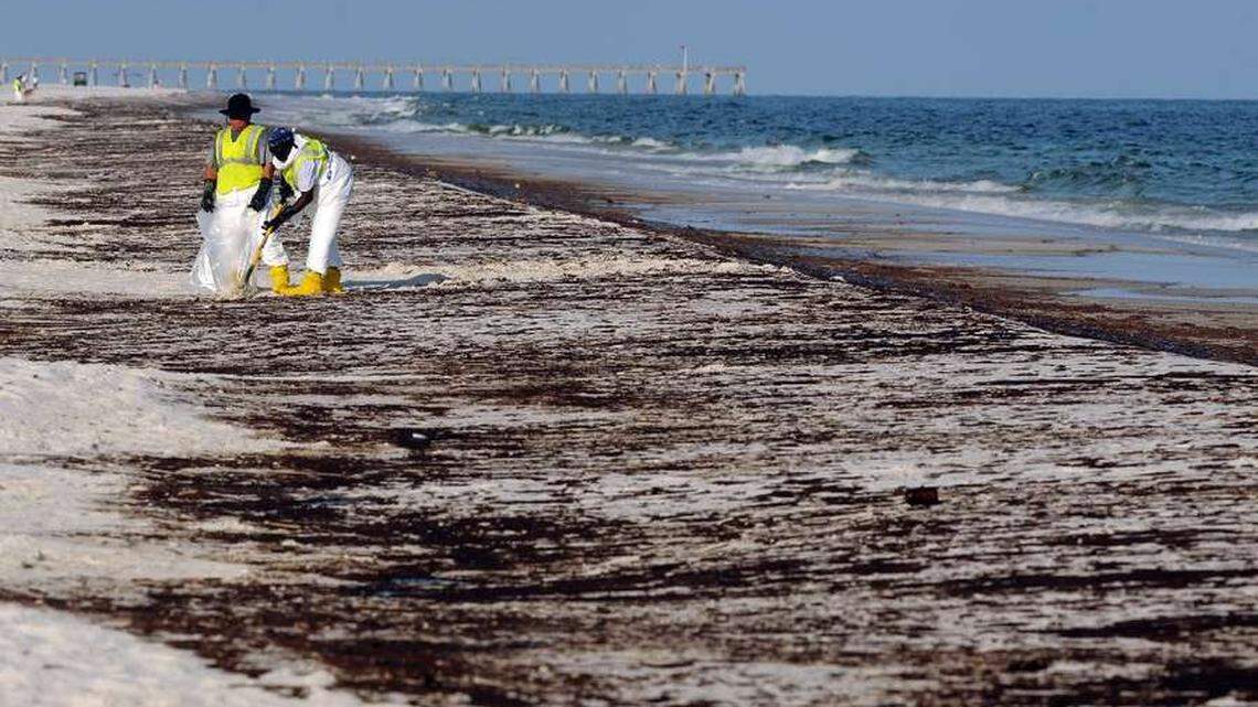 Crews clean up oil from the Deepwater Horizon spill that washed ashore at Pensacola Beach in 2010.