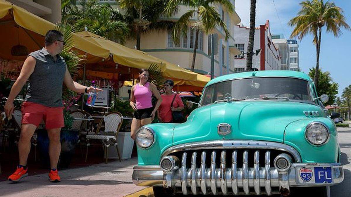 MIAMI BEACH, FLORIDA - MAY 30: People enjoy themselves along the tourist destination of Ocean Drive on May 30, 2025 in Miami Beach, Florida. Reports indicate that international visits to the U.S. were down 14% in March from the same time a year ago. The tourists are being driven away by negative perceptions of the Trump administration's policy towards trade and immigration. (Photo by Joe Raedle/Getty Images)