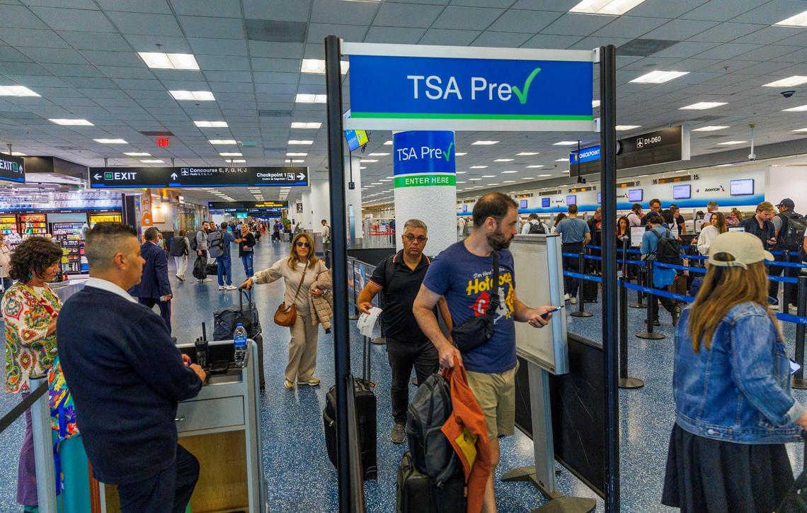 Passengers go through a checkpoint at Miami International Airport as the Transportation Security Administration started enforcing REAL ID for travel on Wednesday, May 7, 2025.