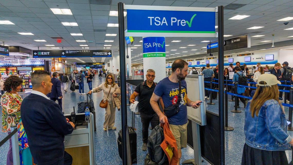 Passengers go through a checkpoint at Miami International Airport as the Transportation Security Administration started enforcing REAL ID for travel on Wednesday, May 7, 2025.