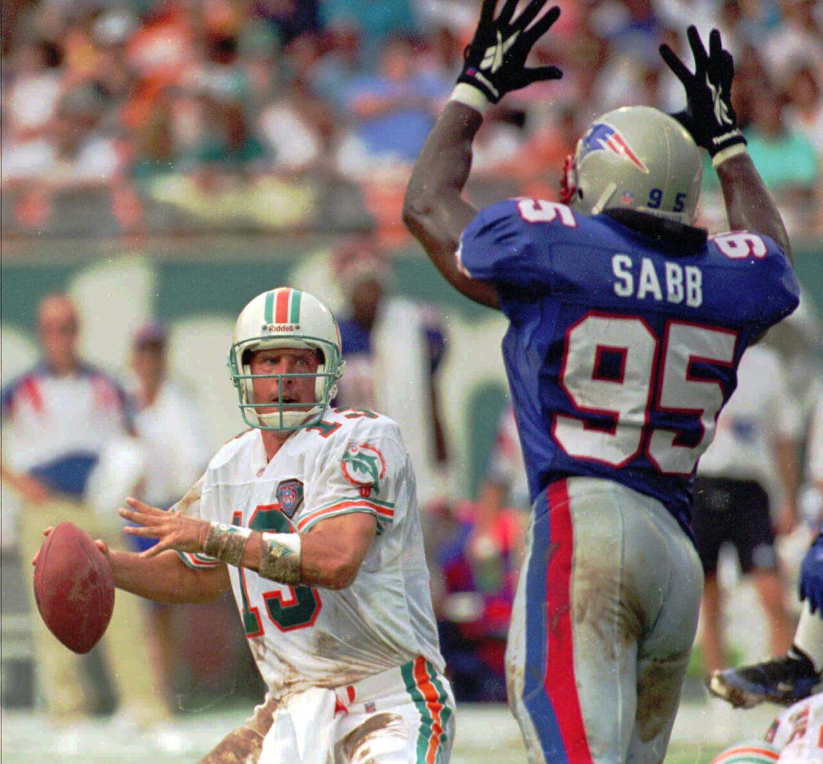 Miami Dolphins quarterback Dan Marino passes over the defense of New England Patriots Dwayne Sabb in the second quarter at Joe Robbie Stadium in Miami, Fla. Sunday, Sept. 4, 1994. Marino was 23 for 42 with 473 yards passing and five touchdowns. The Dolphins won 39-35.