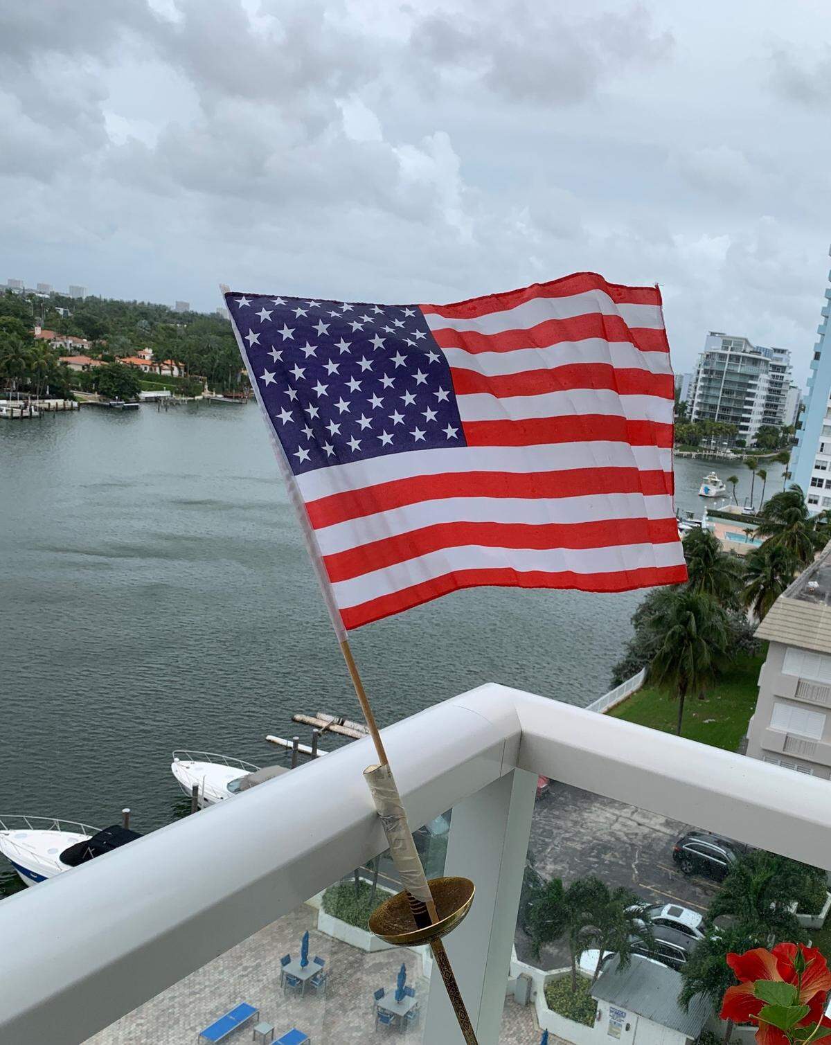 Cuban American Ileana Oroza of Miami Beach flies her American flag from her balcony after Democrat Joe Biden wins Pennsylvania, defeating President Donald Trump.