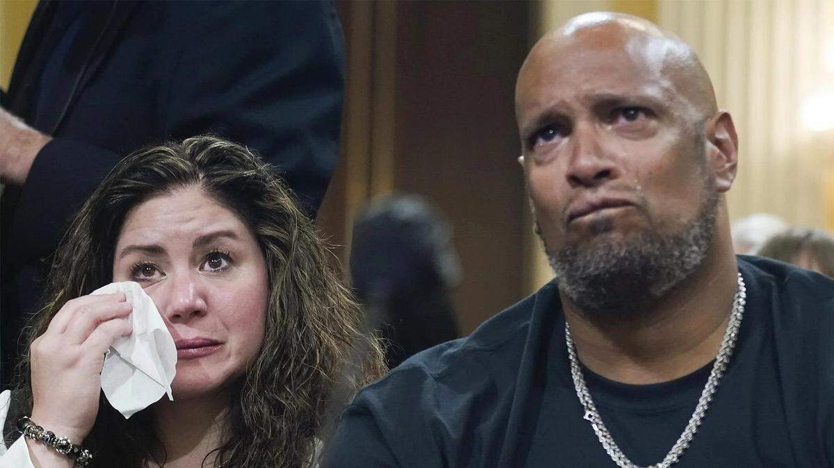 U.S. Capitol Police Sgt. Harry Dunn, right, and Sandra Garza, the longtime partner of Capitol Hill Police Officer Brian Sicknick, who died shortly after the Jan. 6 attack, react as a video of the assault on the U.S. Capitol is played during Thursday’s hearing.
