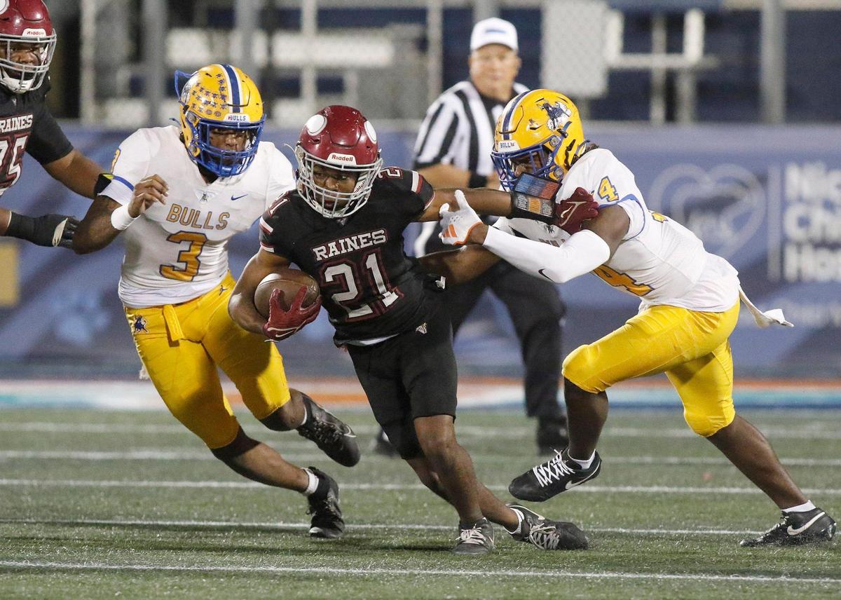 Northwestern Bulls defensive end Deangelo Thompson (3) and cornerback J’vari Flowers (4) attempt to stop Raines Vikings (Jacksonville) running back Ta’darius Washington (21) during Class 3A state championship football game Saturday, December 14, 2024 at Pitbull Stadium in Miami. Andrew Uloza / for Miami Herald