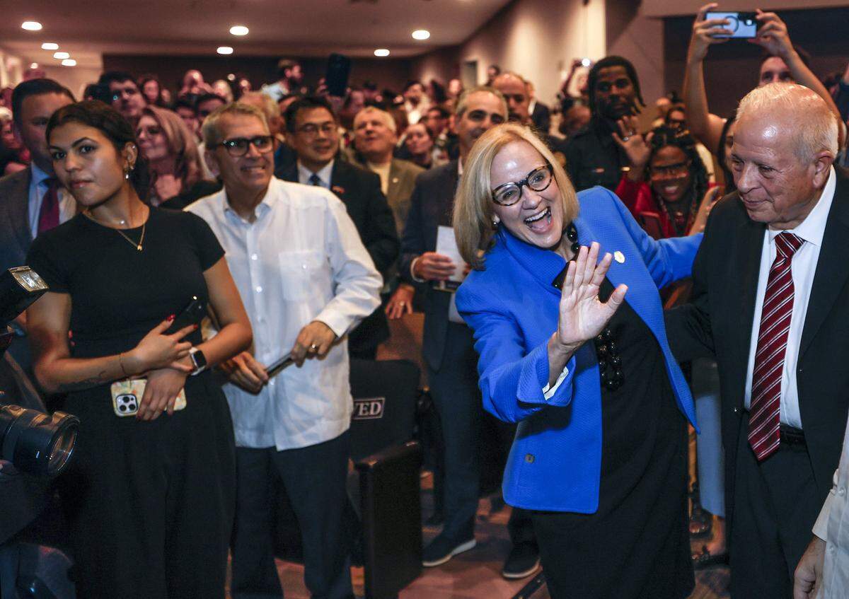 Eileen Higgins stands with Property Appraiser of Miami-Dade County Tomas Regalado as she greets attendees  after her installation ceremony for Mayor of the City of Miami at the Miami-Dade College Wolfson Campus Auditorium in Miami, Florida, on Thursday, December 18, 2025. 