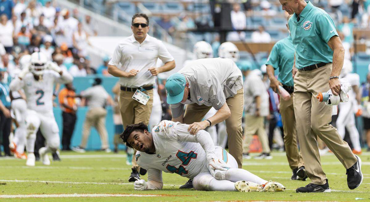 Miami Dolphins linebacker Chop Robinson (44) reacts after sustaining an injury against the New England Patriots in the second half of their NFL game at Hard Rock Stadium on Sunday, Sept. 14, 2025, in Miami Gardens, Fla.