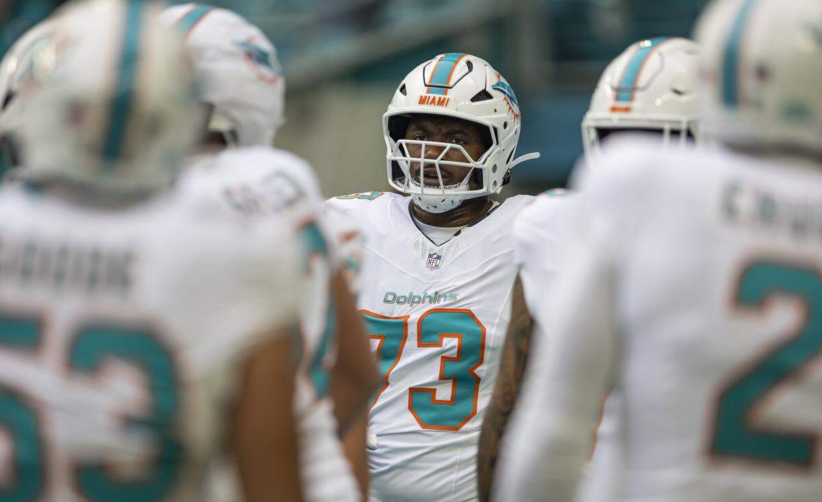 Miami Dolphins guard Austin Jackson (73) huddles with his teammates during warm ups before his NFL game against the New Orleans Saints at Hard Rock Stadium on Sunday, Nov. 30, 2025, in Miami Gardens, Fla.
