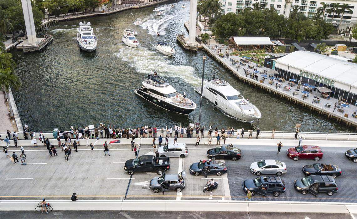 Protestors block the Miami River Bridge and prevent it from opening for large yachts to pass along the Miami River in downtown Miami on Saturday, June 27, 2020.