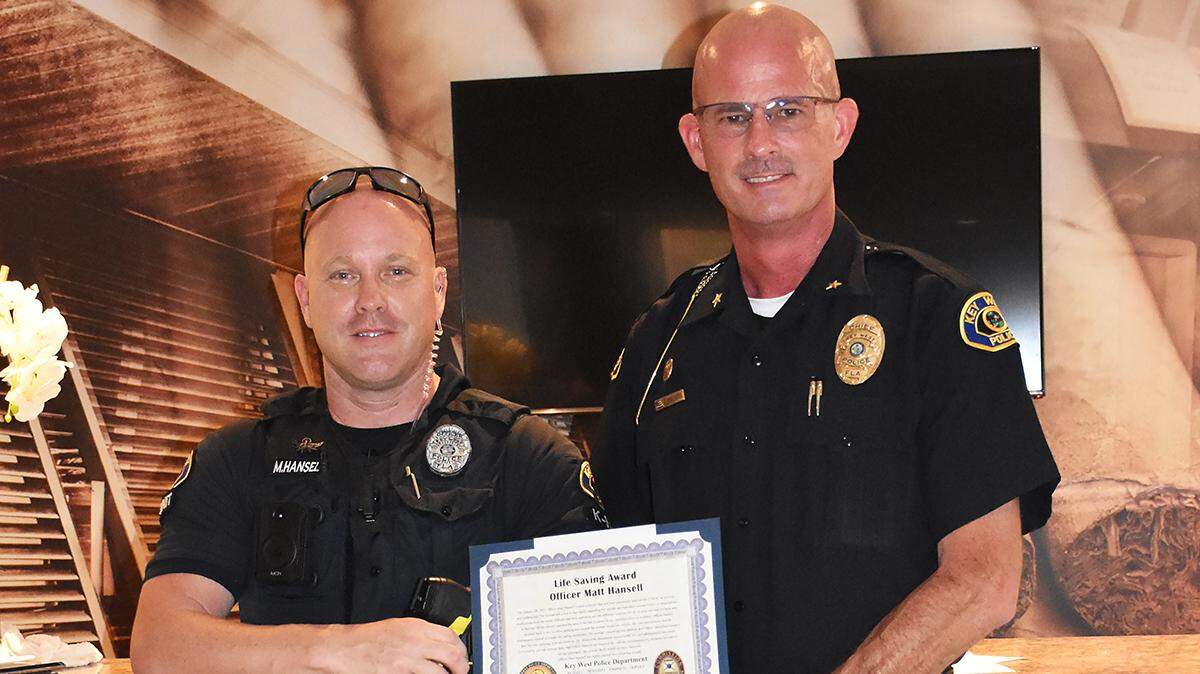 Key West Police Officer Matt Hansell poses with Chief Sean Brandenburg. Hansell was recognized for saving a woman from a near-fatal drug overdose on Jan. 28, 2023.