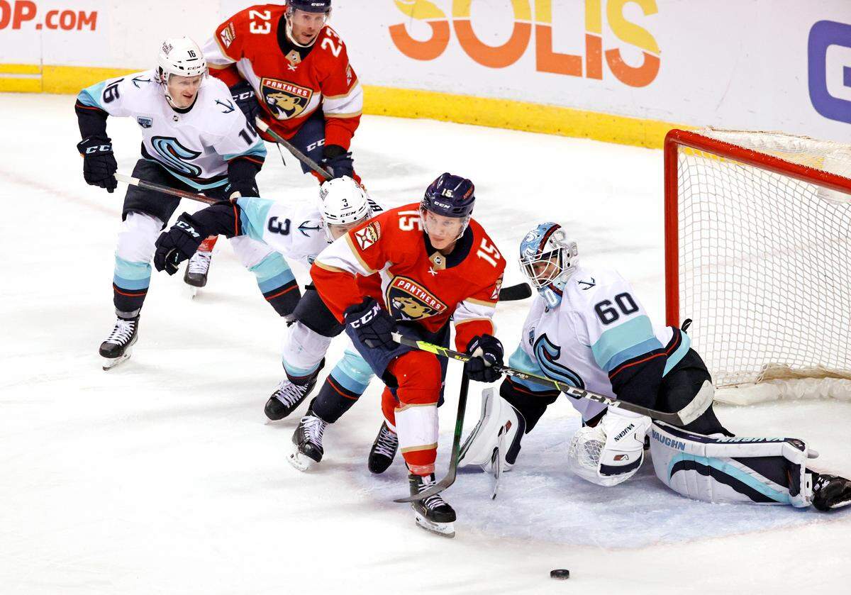 Seattle Kraken goaltender Chris Driedger (60) Kraken defenseman William Borgen (3) and center Jared McCann (16) defend the goal from Florida Panthers center Anton Lundell (15) during the second period of an NHL game at the FLA Live Arena on Saturday, November 27, 2021 in Sunrise, Fl.