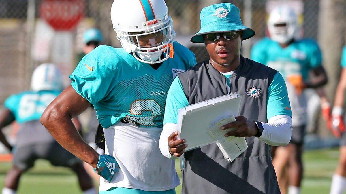 Miami Dolphins safety Minkah Fitzpatrick talks with a coach during Friday’s practice.