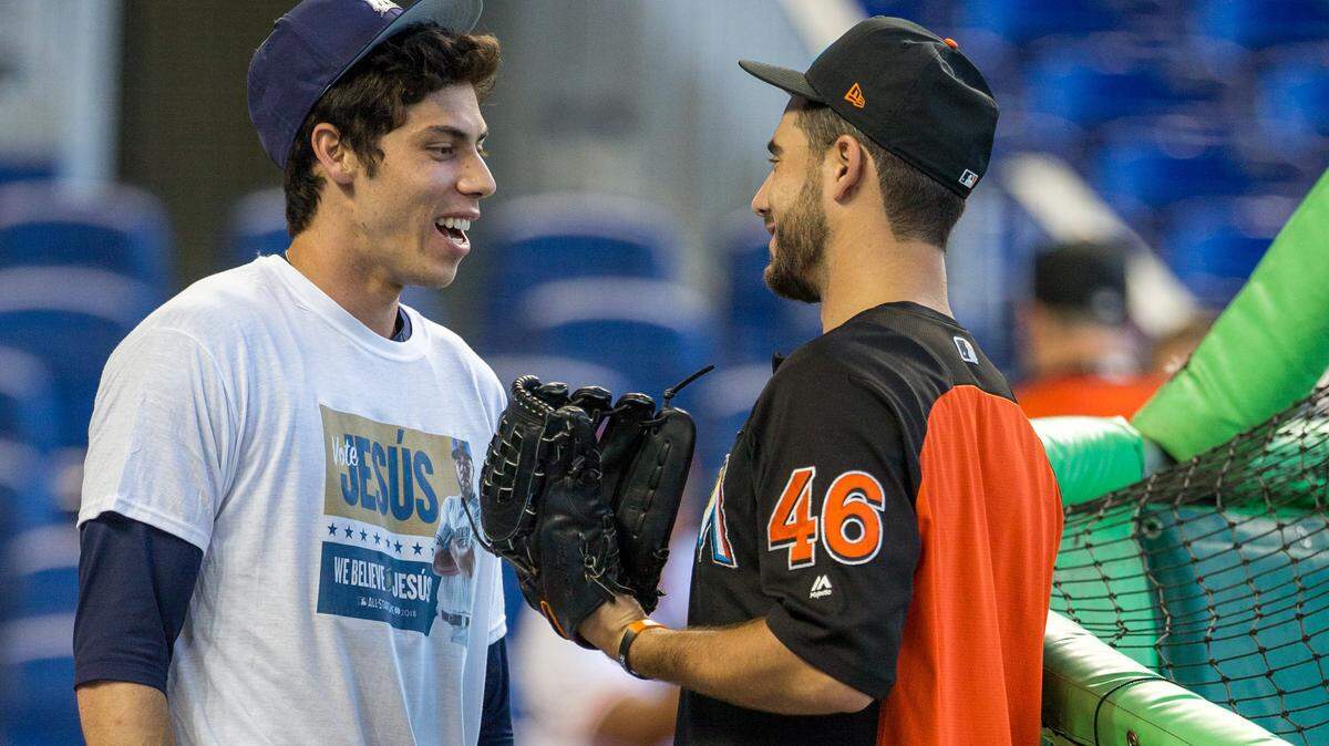 Former Miami Marlins Christian Yelich, left, now with the Brewers, shares a moment during batting practice with Marlins pitcher Kyle Barraclough (46) in his return to Marlins Park since his trade to Milwaukee, Monday, July 9, 2018.
