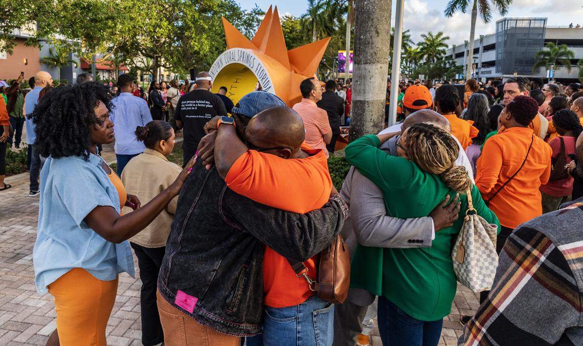 Attendees hug during a candlelight vigil celebrating the life of  Coral Springs Vice Mayor Nancy Metayer on Friday evening at Coral Springs City Hall. 