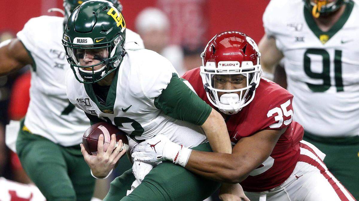 FILE - In this Dec. 7, 2019, file photo, Oklahoma linebacker Nik Bonitto (35) sacks Baylor quarterback Charlie Brewer (12) during an NCAA college football game for the Big 12 Conference championship in Arlington, Texas. Bonitto was selected to The Associated Press Preseason All-America first team defense, Monday Aug. 23, 2021.(Ian Maule/Tulsa World via AP, File)