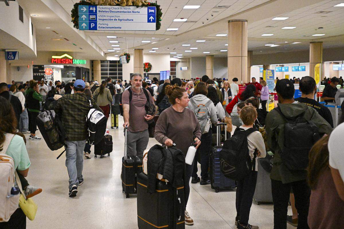 Passengers wait at the airport.