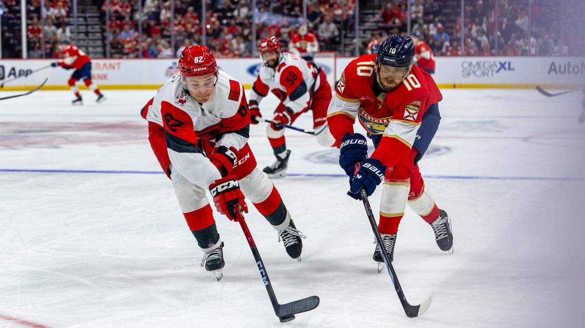 Florida Panthers left wing A.J. Greer (10) fights for possession of the puck against Carolina Hurricanes defenseman Charles Alexis Legault (62) during the third period of an NHL game at Amerant Bank Arena on Monday, September 29, 2025, in Sunrise, Fla.