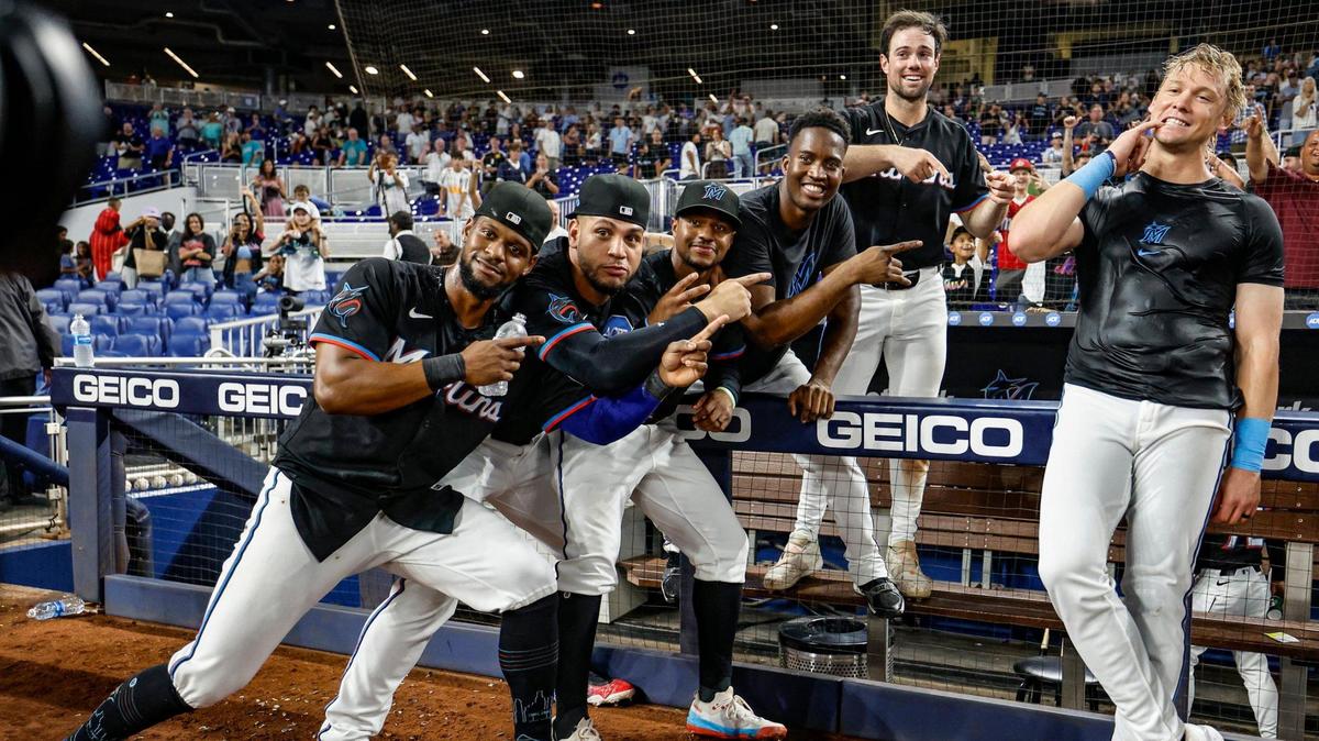 Miami Marlins teammates celebrate the win with Kyle Stowers (28), seen at right, after the game. Stowers hit a home run on a fly ball to right field bringing in Javier Sanoja (46) to score in the 10th inning against the Kansas City Royals at loanDepot park in Miami, Florida, on Friday, July 18, 2025.