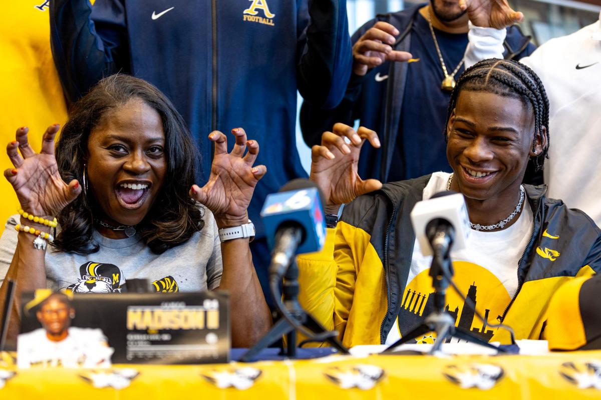 St. Thomas Aquinas wide receiver James Madison II reacts with his mother Mia Madison after officially signing with University of Missouri during signing day at St.Thomas Aquinas High School in Fort Lauderdale, Florida, on Wednesday, December 20, 2023.