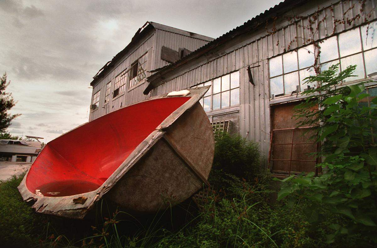 An old boat sits next to a historic building at Dinner Key, near Miami City Hall. The building was once a Pan Am hanger during the 1940s.
