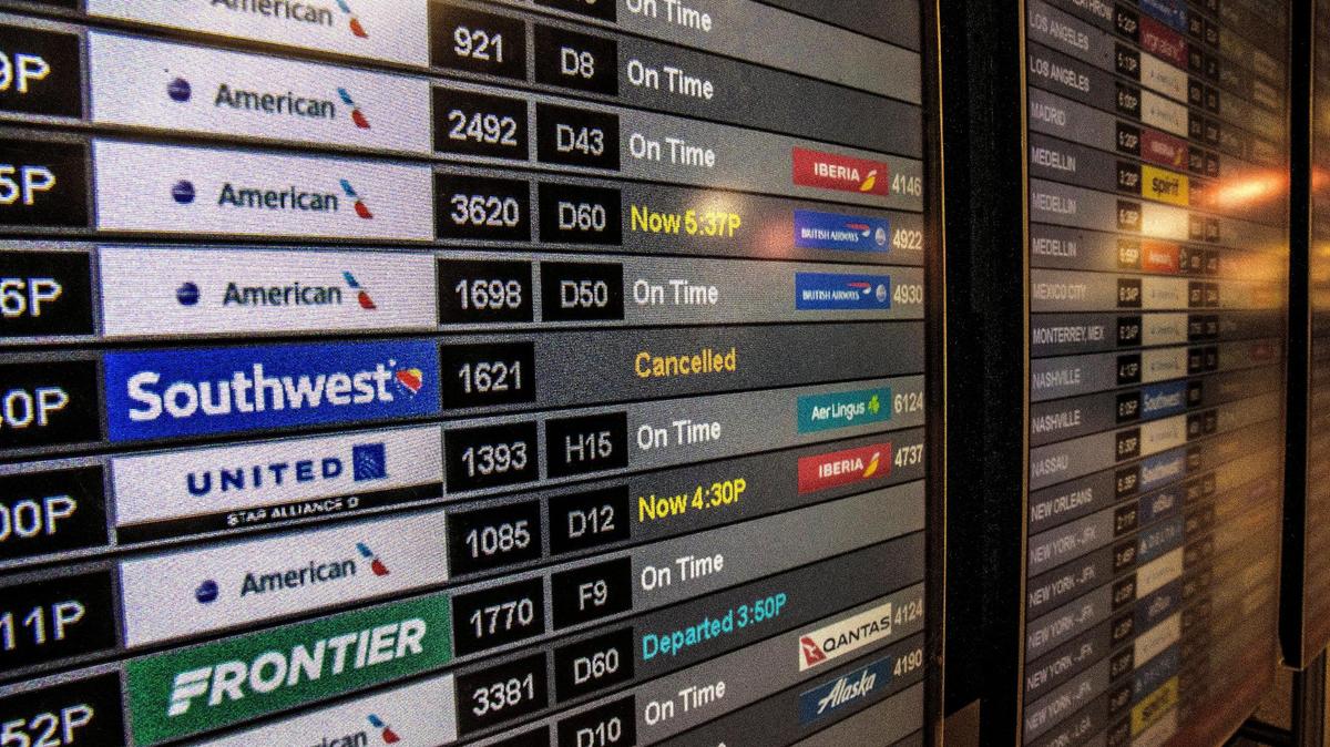 Information monitors shows canceled flights at Miami International Airport on Tuesday, December 27, 2022.