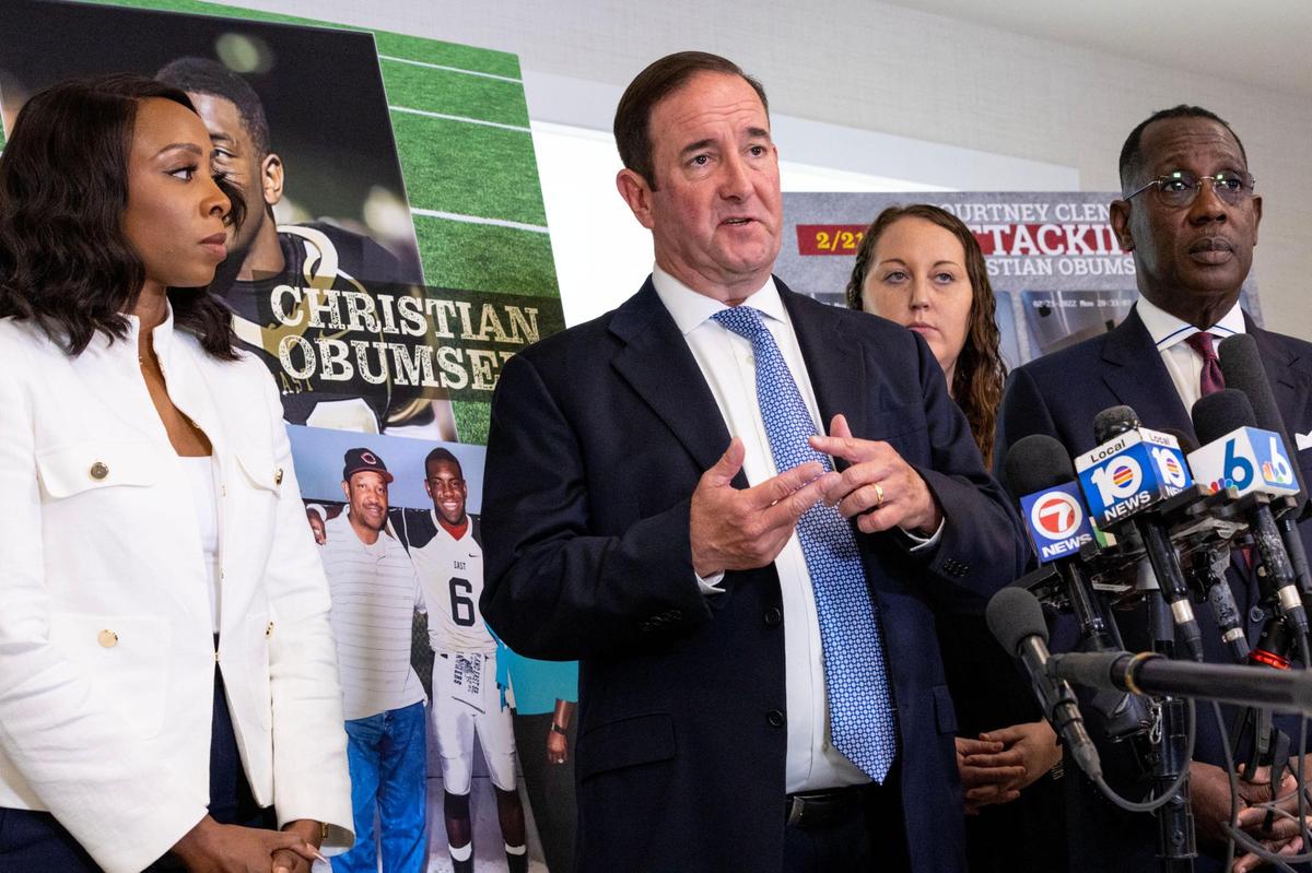 Lawyer Michael Haggard, center, speaks to the media regarding the criminal court hearing of Courtney Clenney, who admitted to killing Obumseli and claimed self-defense, as lawyer Larry Handfield, right, and Karen Egbuna, cousin of Christian “Tobi” Obumseli, right, look on during a press conference at Haggard Law Firm in Coral Gables, Florida, on Tuesday, May 9, 2023. The press conference was held after Tuesday morning’s criminal court hearing of admitted killer Courtney Clenney as Christian Obumseli’s family discussed the case publicly for the first time.