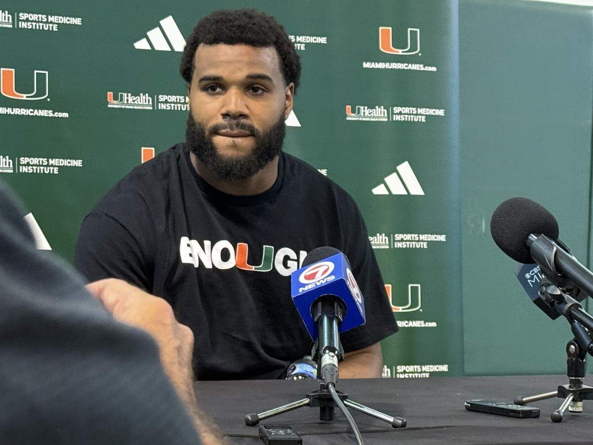 Miami Hurricanes defensive lineman Akheem Mesidor wears a shirt that says “Enough” during a post practice interview session on July 31, 2025, at the Carol Soffer Indoor Practice Facility on the University of Miami campus in Coral Gables, Florida.