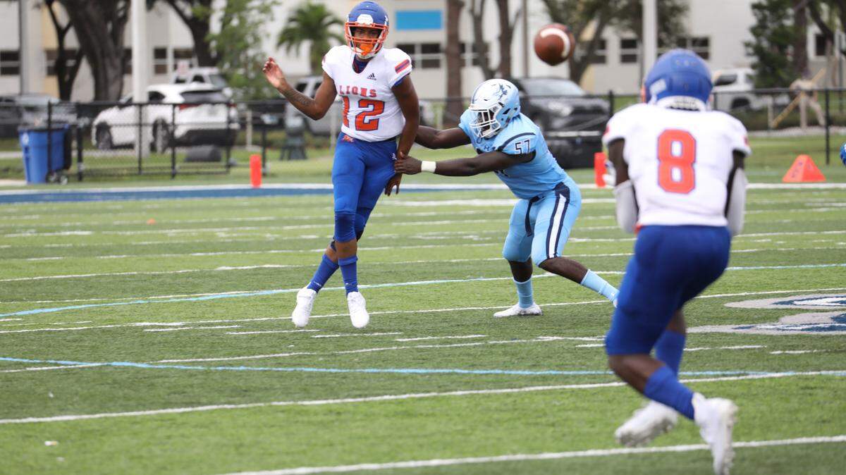 Florida Memorial sophomore quarterback Antoine Williams evades a Keiser defender while attempting to pass to freshman running back George Young.