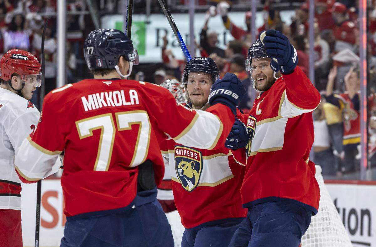 Florida Panthers defenseman Niko Mikkola (77) celebrates with his teammates after scoring against Carolina Hurricanes goaltender Pyotr Kochetkov (52) in the first period of Game 3 during the Eastern Conference final of the NHL Stanley Cup playoffs at Amerant Bank Arena on Saturday, May 24, 2025, in Sunrise, Fla.
