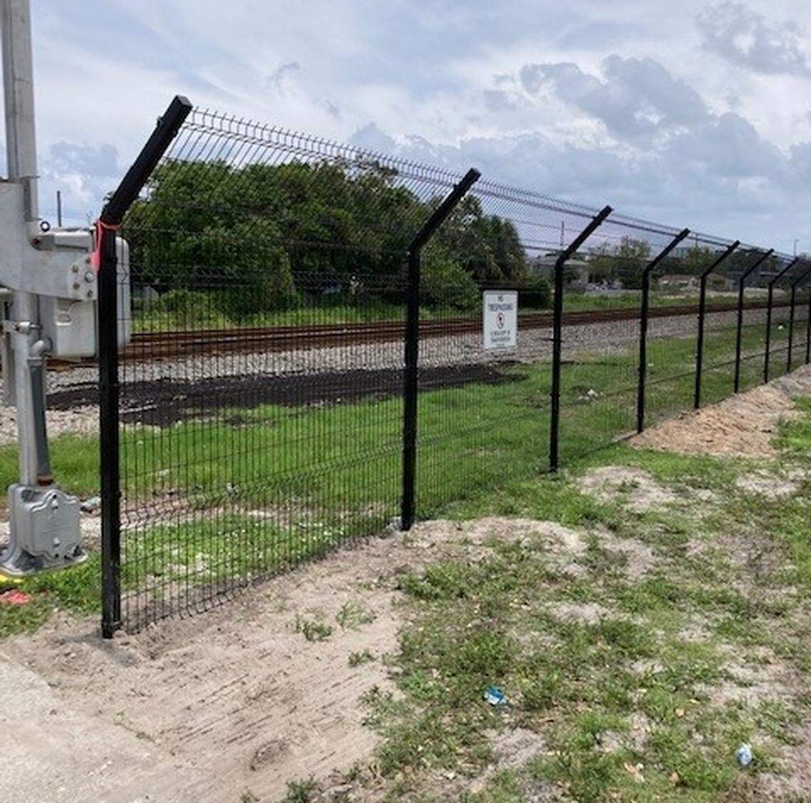 New fencing near the Tri-Rail station at the Broward Boulevard/Interstate 95 exchange in Fort Lauderdale, west of the Brightline corridor, is angled at the top to make it difficult to climb over. Experts say strategically placed fencing can help reduce train deaths, but it is sparse along Brightline’s tracks.