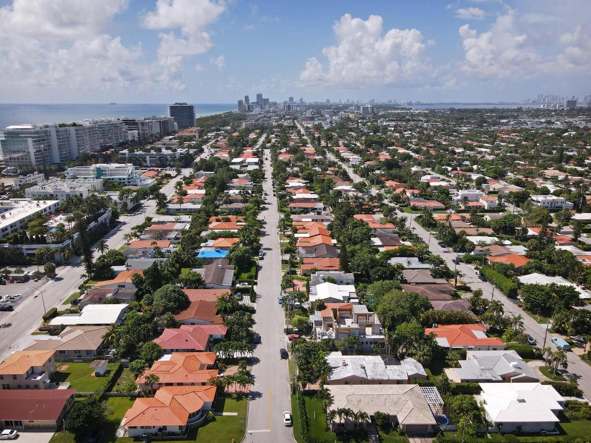 Few locals can afford to buy in Miami. Above: An aerial view of single-family homes and condos in Surfside, looking south toward Downtown Miami, on August 19, 2021.
