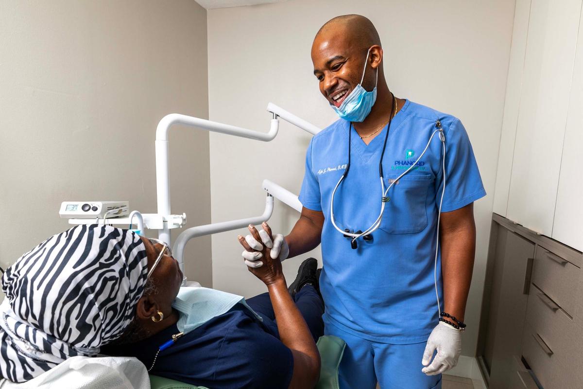 Dr. Kyle J. Phanord interacts with a patient after a cleaning at his office on Monday, June 9, 2025, in North Miami, Florida.