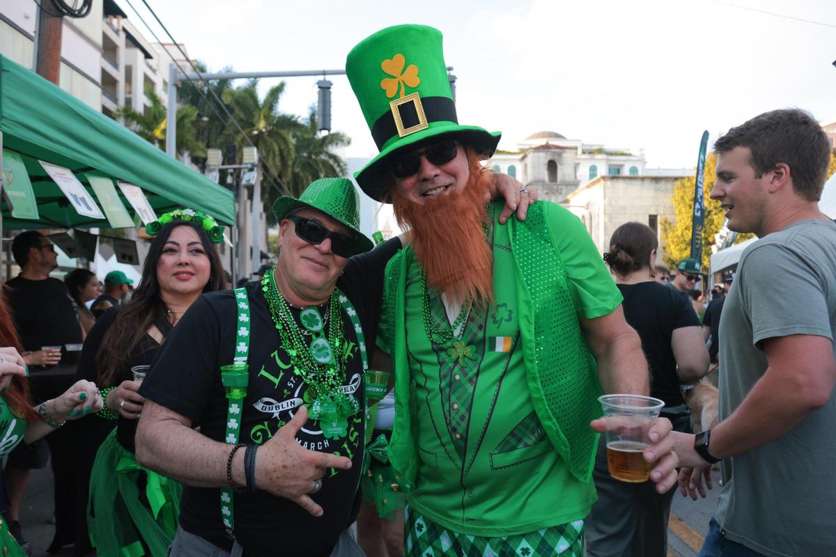 Tony Garay, left, and Gerry Silva, right, get their picture taken while enjoying the John Martin’s 32nd Annual St. Patrick’s Day Street Festival in Coral Gables, Florida, Saturday, March 15, 2025.