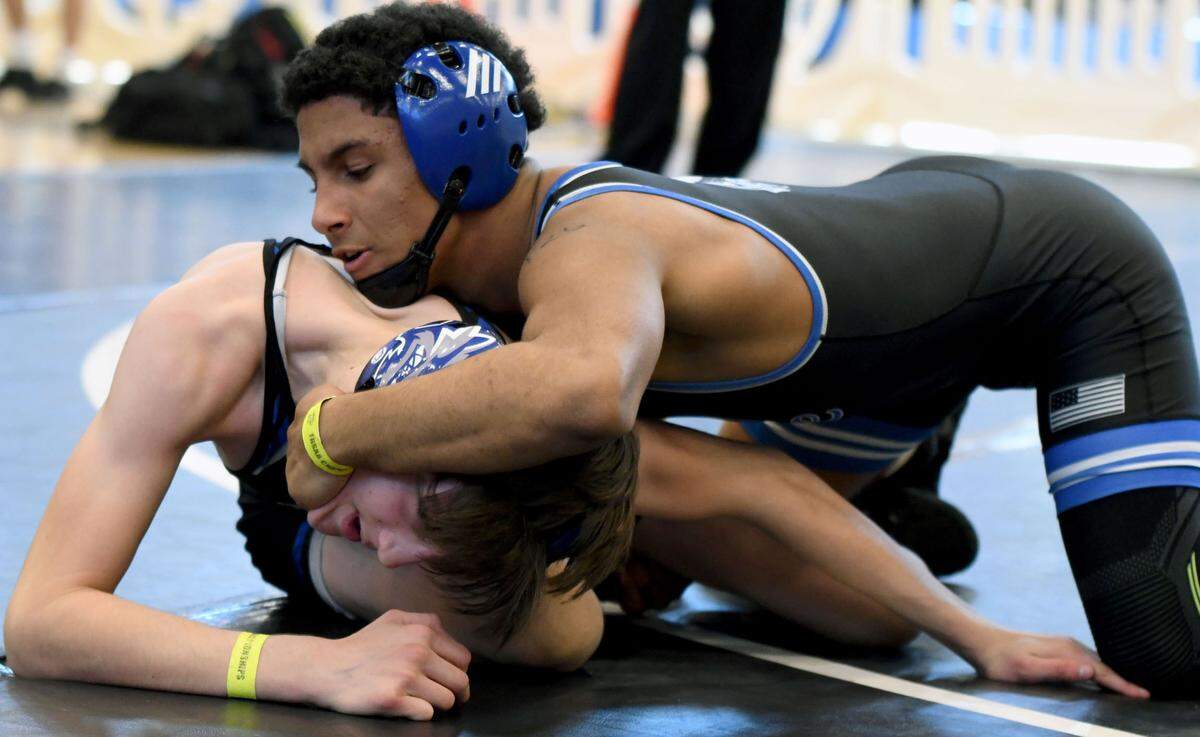South Dade’s Luis Acevedo works his way to a tech fall win in a 120-pound match against Mark Bofantae of Wellington Community on Saturday at the FHSAA Duals wrestling state championships at Osceola High School in Kissimmee, Fla.