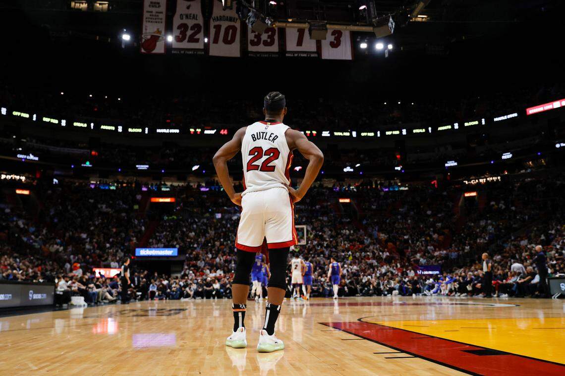 The Miami Heat retired number banners hang above the court as Heat forward Jimmy Butler (22) looks on during during the second quarter of their NBA basketball game against Dallas Mavericks at the FTX Arena on Tuesday, February 15, 2022 in Miami, Fl.
