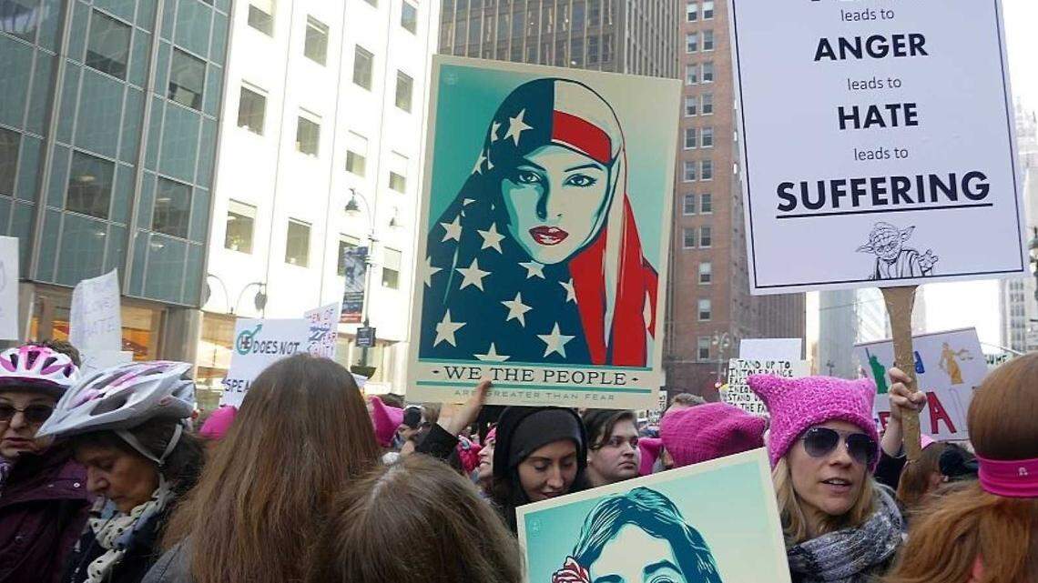 Women in pink hats protest against the Trump administration.