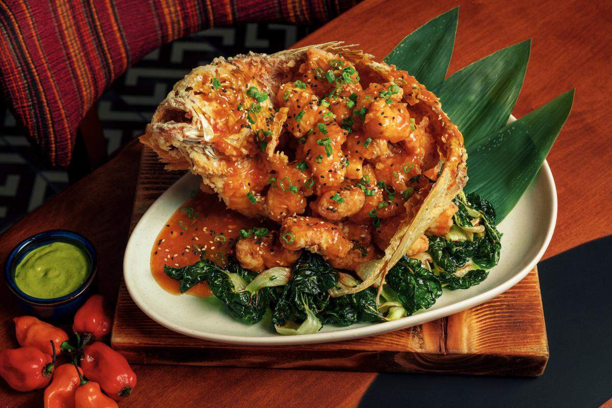 Pescado frito Nikkei, a whole snapper deboned and fried with spicy sauce, bok choy and white chaufa, is one of the specialties at Jarana in Aventura.