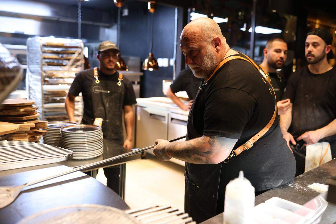 Italian chef Francesco Martucci slides a pizza into the oven at his new Wynwood restaurant.